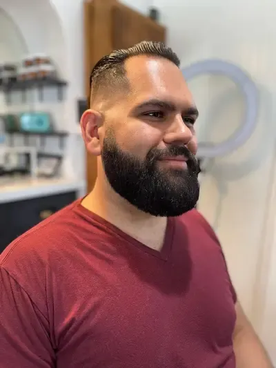 A man with a beard who just got a professional beard trim with a straight razor line up in Richmond, Virginia